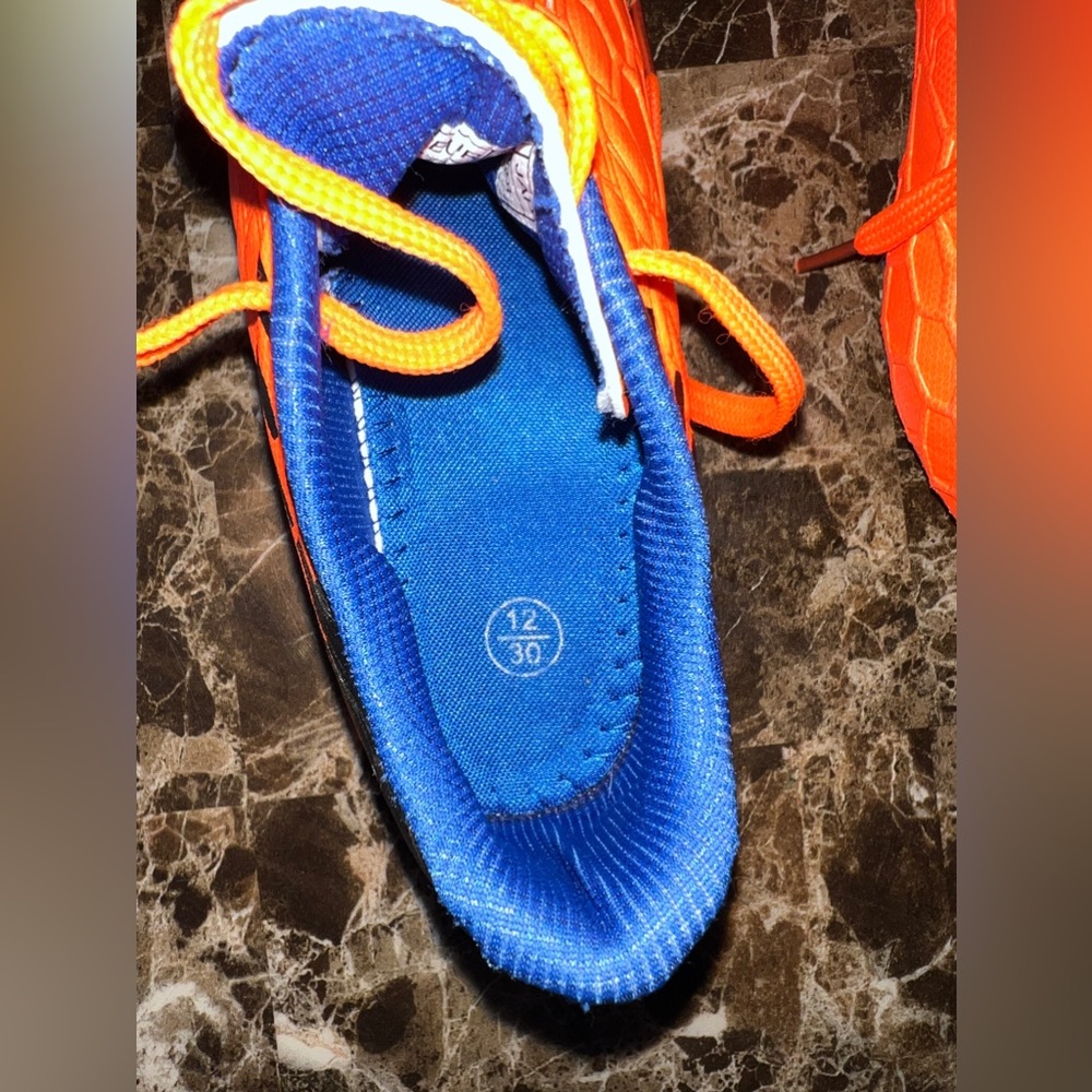 Orange and blue soccer cleats, size 12